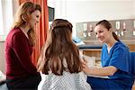 Nurse talking to patient and mother