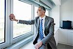 Businessman looking out of office window