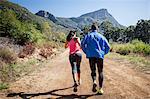 Young couple jogging in forest