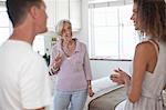 Senior woman guiding couple in holiday apartment