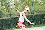 Mature woman playing tennis