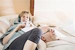 Couple lying on bed relaxing