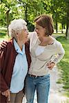 Senior woman and granddaughter standing in park