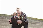 Mid adult man flying kite with son on beach, Bloemendaal aan Zee, Netherlands