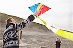 Mid adult man and son preparing to fly kite on beach, Bloemendaal aan Zee, Netherlands