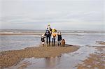 Mid adult parents with son, daughter and dog strolling on beach, Bloemendaal aan Zee, Netherlands