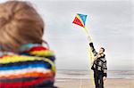 Mid adult man and son with kite on beach, Bloemendaal aan Zee, Netherlands