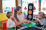 Teacher and pupils learning road crossing at nursery school