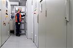 Technician doing a check in power station control room