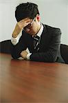 Desperate Japanese young businessman in a suit