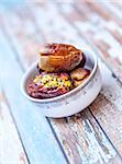 Dates fruit in a bowl closeup on wooden background