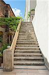 Closeup details of set of old stone steps against wall