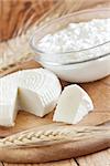 Tzfat cheese and cottage cheese with wheat grains. Symbols of judaic holiday Shavuot. Selective focus.