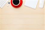 Office table with notepad, computer and coffee cup. View from above with copy space