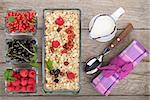 Healty breakfast with muesli, berries and milk. View from above on wooden table