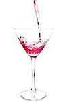 filling a glass with red cocktail and splashing on a white background