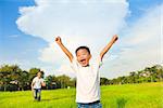 happy father and son playing in meadow