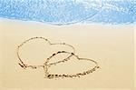 hearts on the sand seashore - love and  romantic concept