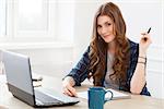 Student, office. Cute, beautiful woman by the table