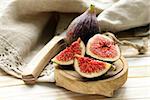 fresh ripe purple figs on wooden board