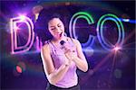 Pretty girl singing against digitally generated colourful disco text