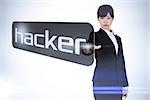 Businesswoman pointing to word hacker against white background with vignette