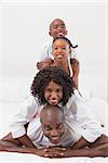 Happy family posing together in bed at home in the bedroom