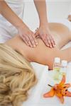 Blonde enjoying a back massage at the health spa