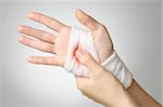 Injured hand with bloody white gauze bandage