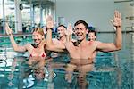 Fitness class doing aqua aerobics in swimming pool at the leisure centre