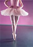 Graceful ballerina standing en pointe in the ballet studio