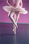Graceful ballerina dancing en pointe in the ballet studio