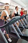 Row of people working out on treadmills at the gym