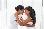 Mother and daughter embracing in the morning at home in bathroom