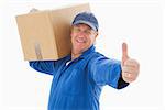 Happy delivery man holding cardboard box on white background