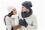 Attractive young couple in warm clothes on white background