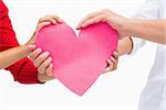 Couples hands holding pink heart on white background
