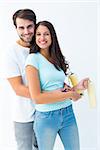 Happy young couple painting together on white background