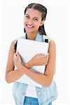 Pretty student holding her laptop on white background