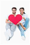 Cute couple sitting holding red heart on white background