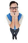 Geeky hipster looking nervously at camera on white background