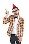 Geeky hipster in party hat pointing on white background