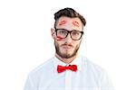 Geeky hipster with kisses on his face on white background