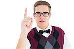 Geeky hipster looking at camera and pointing up on white background