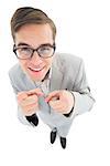 Geeky hipster smiling and pointing at camera on white background