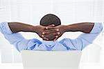 Relaxed businessman sitting in his chair in his office