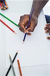 Man drawing with colour pencils in his office