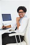 Hipster businessman working at his desk in his office