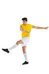 Football player in yellow jersey kicking on white background