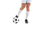 Football player kicking the ball on white background